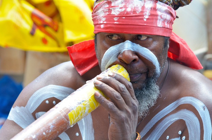 Aboriginal Indigenous Australian man play on Didgeridoo in Sydney Australia